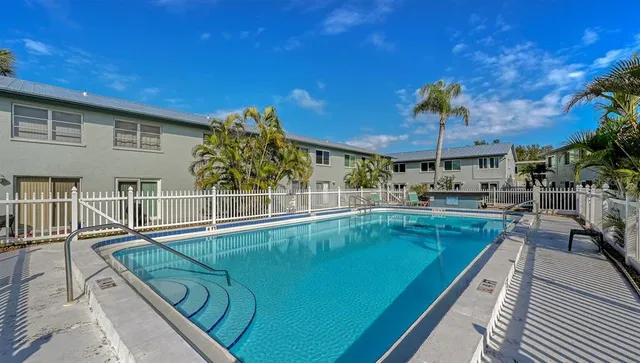 a view of a patio with swimming pool table and chairs