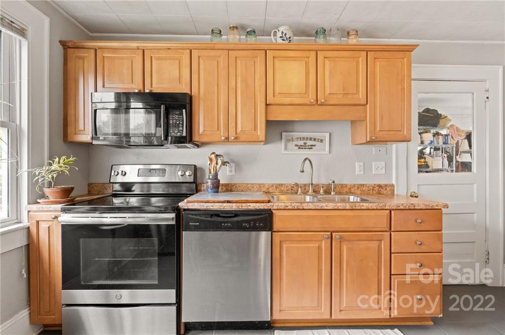 136 Round Top Road Asheville, NC 28803 - Photo 17 of 34 a kitchen with stainless steel appliances granite countertop a stove and a microwave