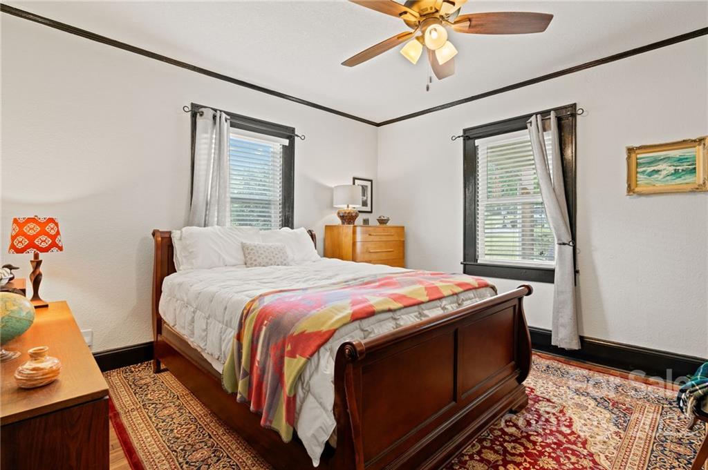 136 Round Top Road Asheville, NC 28803 - Photo 21 of 34 a bedroom with a bed and a window