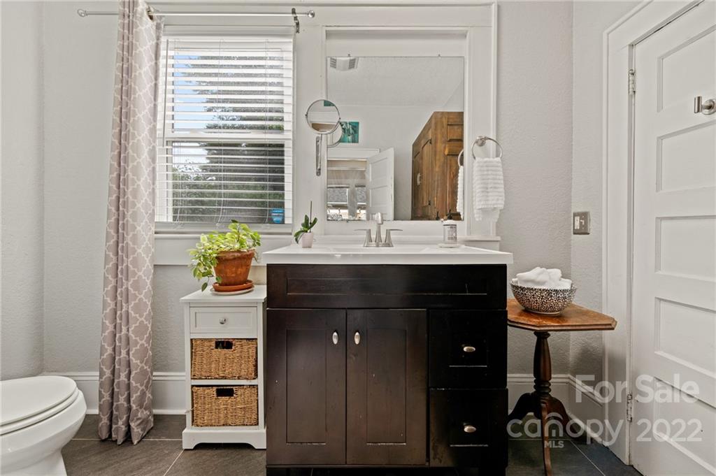 136 Round Top Road Asheville, NC 28803 - Photo 24 of 34 a bathroom with a sink vanity and toilet