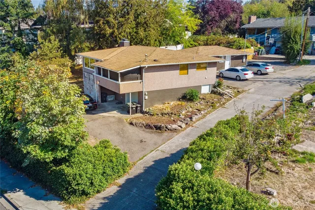 an aerial view of a house with garden space and sitting area