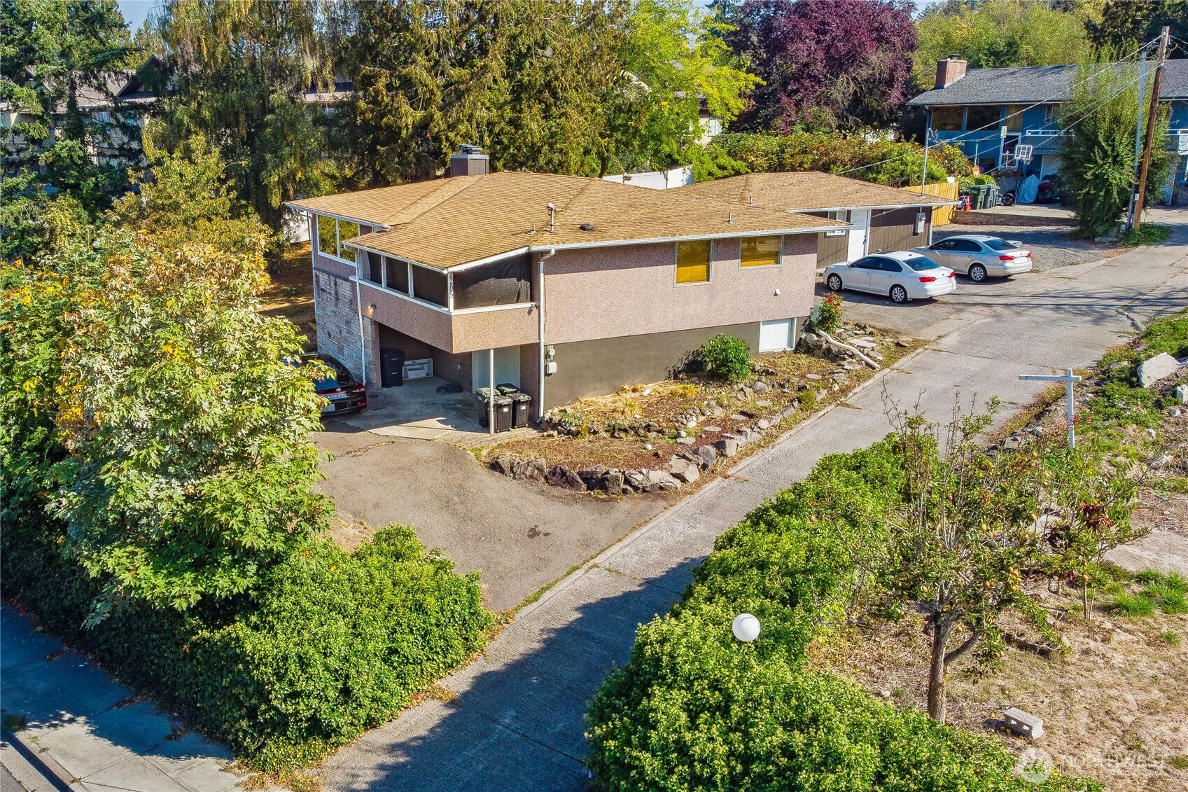 an aerial view of a house with garden space and sitting area