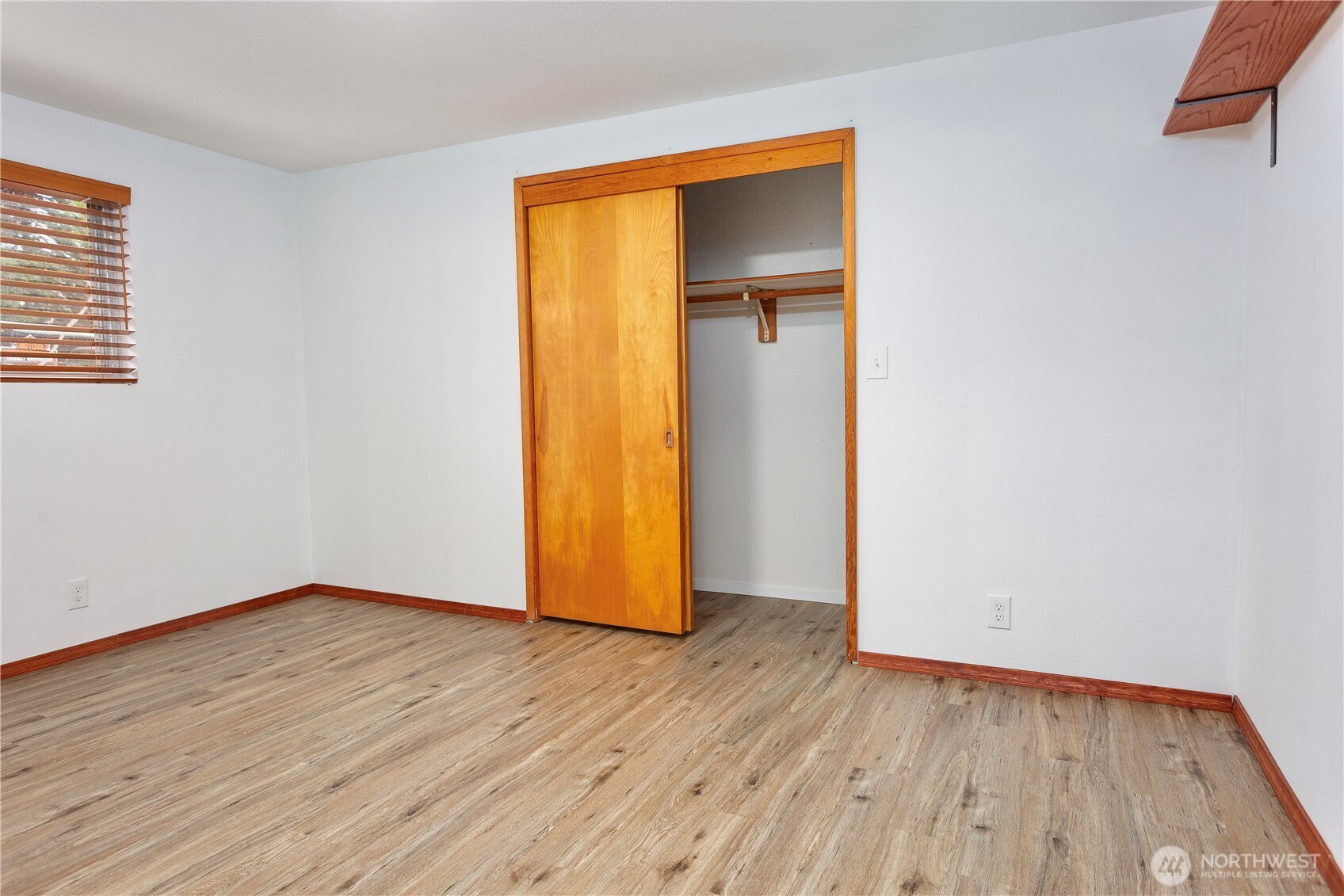 2205 South Meridian Puyallup, WA 98372 - Photo 12 of 39 a view of an empty room with wooden floor and a window