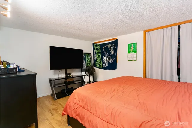 a bedroom with a bed and a flat screen tv