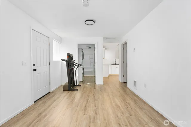 a view of a room with wooden floor and bathroom