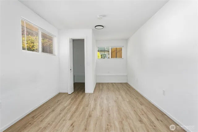 an empty room with a hardwood and wooden floor