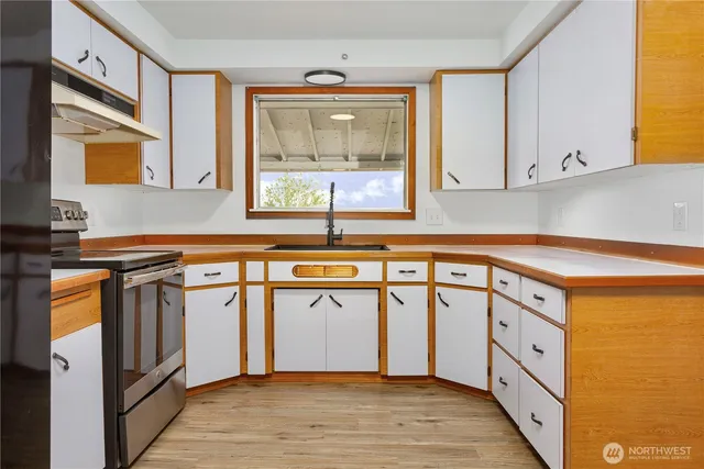 a kitchen with stainless steel appliances granite countertop a stove and a window