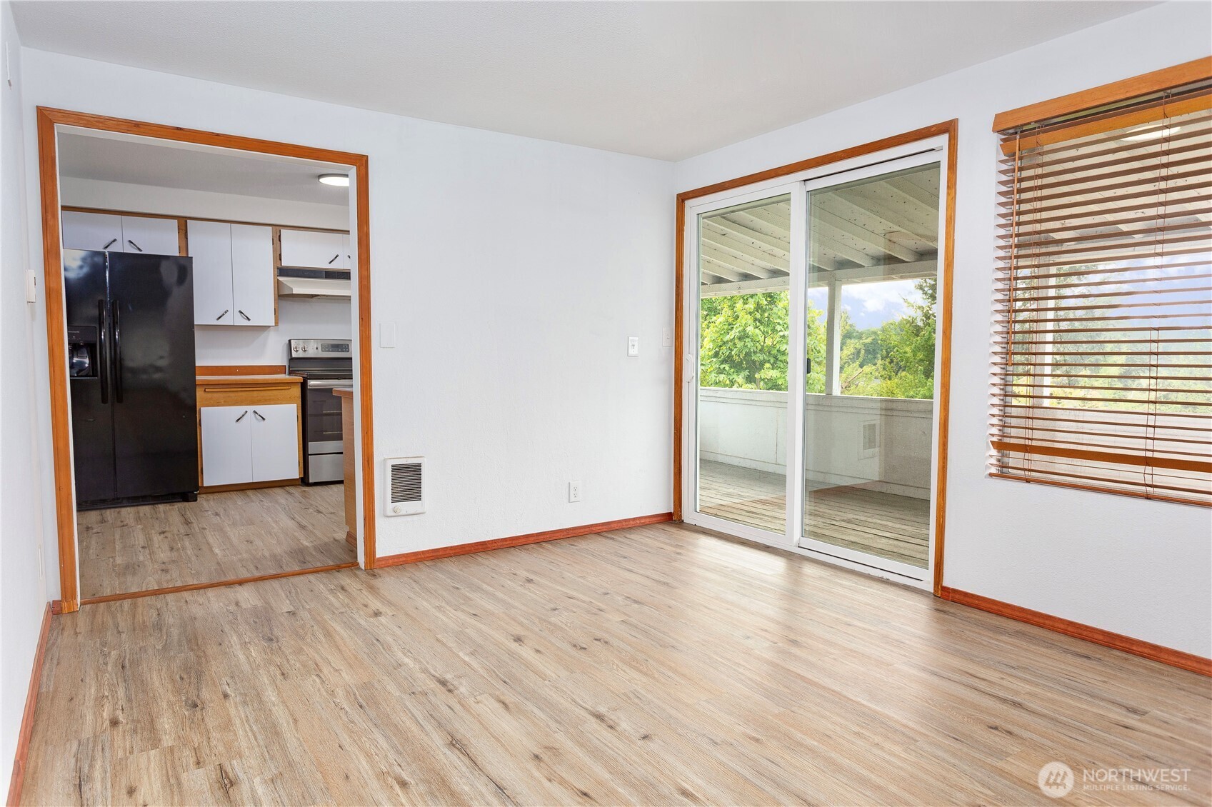 2205 South Meridian Puyallup, WA 98372 - Photo 9 of 39 an empty room with wooden floor and windows