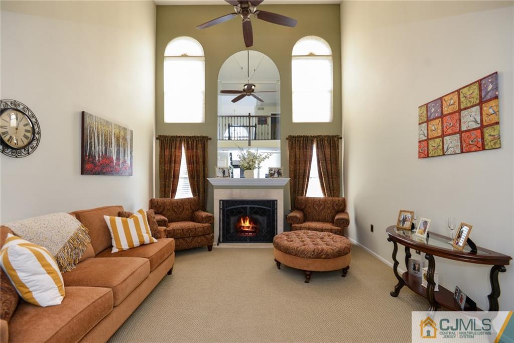 135 Disbrow Road Old Bridge, NJ 07747 - Photo 12 of 25 a living room with furniture a fireplace and a chandelier