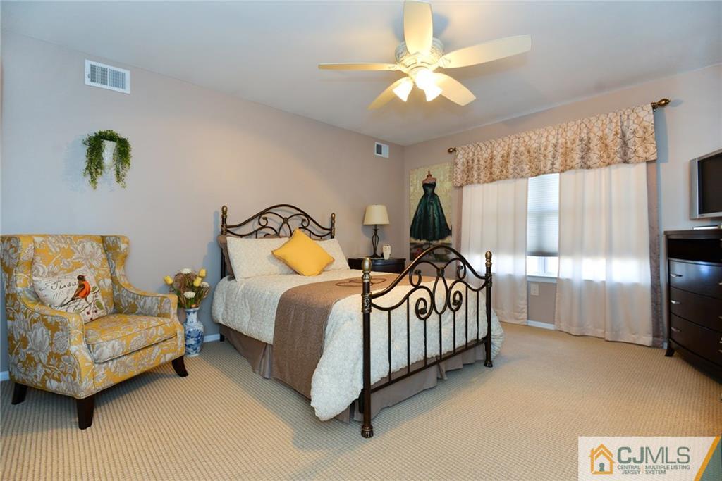 135 Disbrow Road Old Bridge, NJ 07747 - Photo 15 of 25 a bedroom with a bed and a chandelier