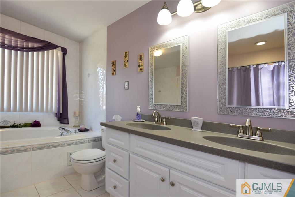 135 Disbrow Road Old Bridge, NJ 07747 - Photo 22 of 25 a bathroom with a granite countertop sink and a mirror