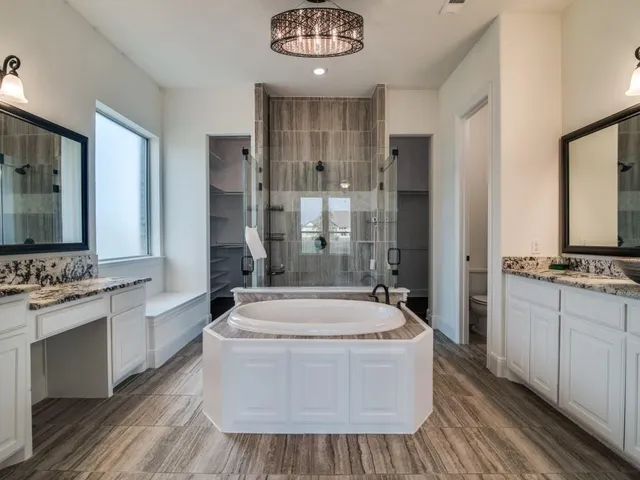 a spacious bathroom with sink shower and bathtub