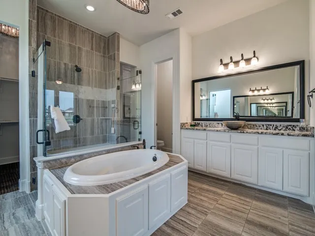 a bathroom with a tub sink and mirror