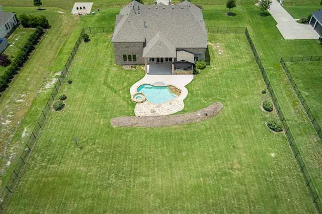 an aerial view of a house with a yard basket ball court and outdoor seating