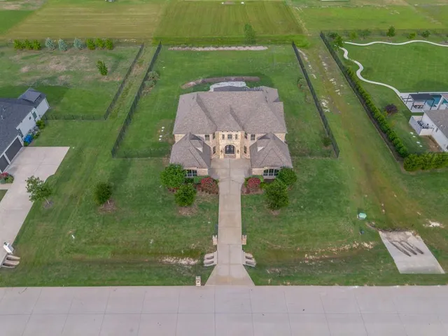 an aerial view of a house with a yard