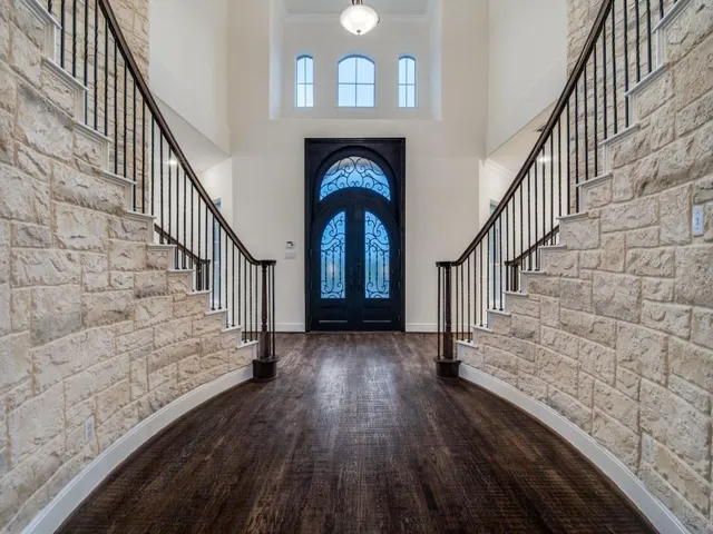 a view of entryway and hall with wooden floor