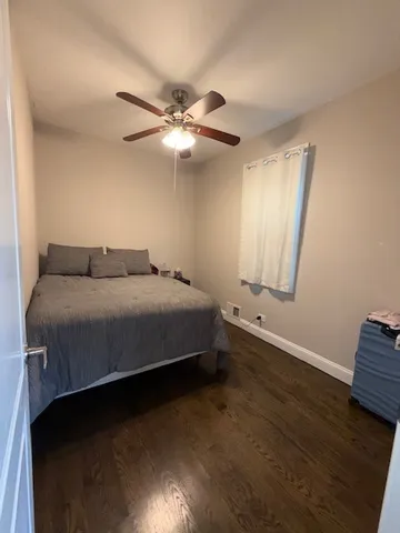a view of a room with wooden floor and a window