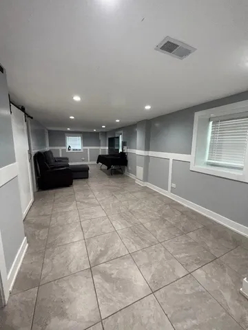 a bathroom with a sink a toilet a mirror and shower