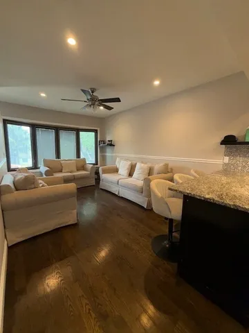 a living room with furniture and a kitchen