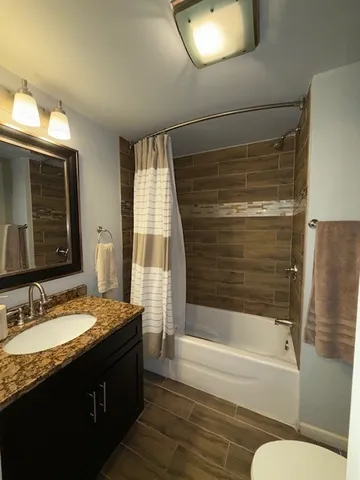 a bedroom with a bed and a ceiling fan