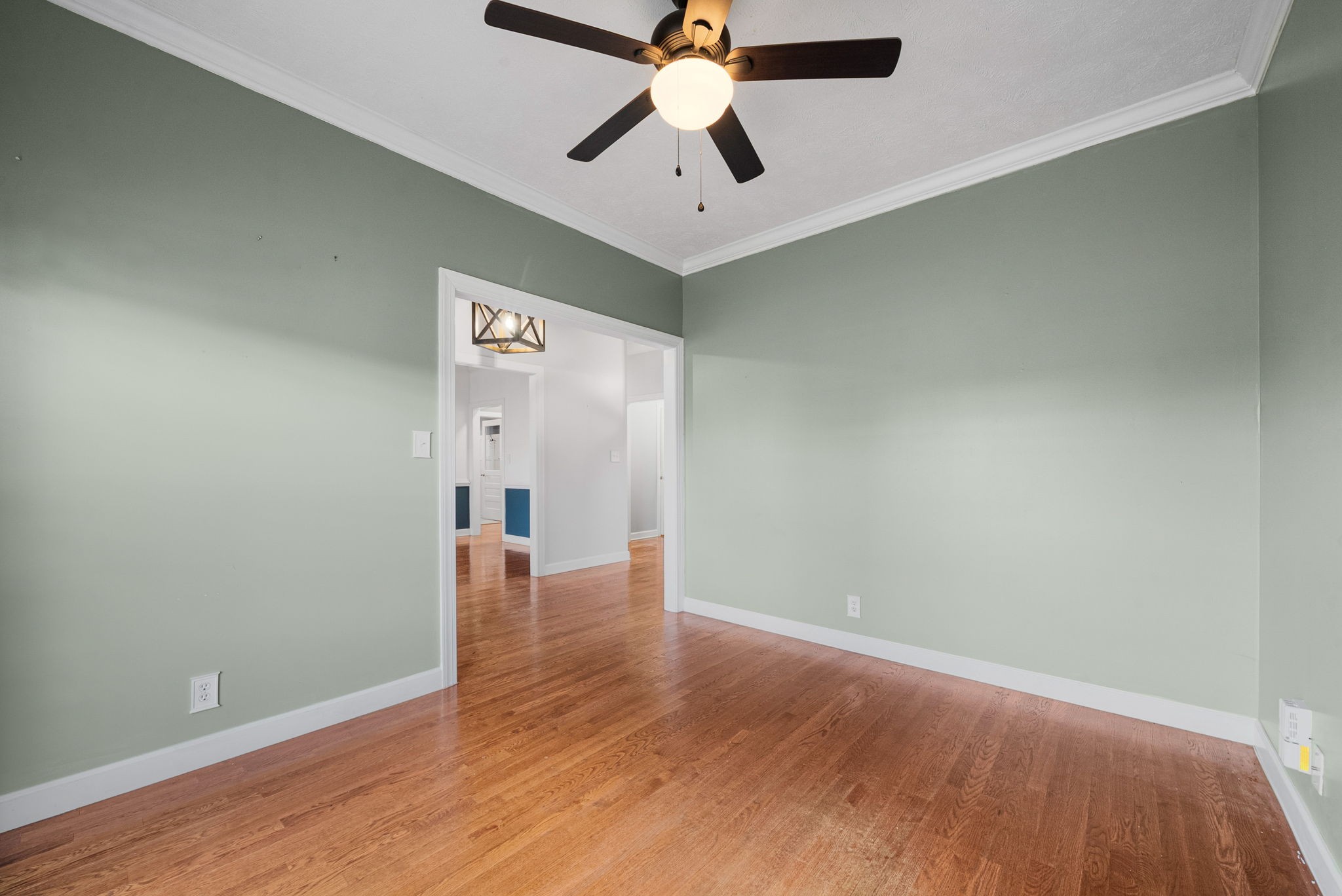 1026 Bluejay Lane Adams, TN 37010 - Photo 11 of 56 an empty room with wooden floor ceiling fan and windows