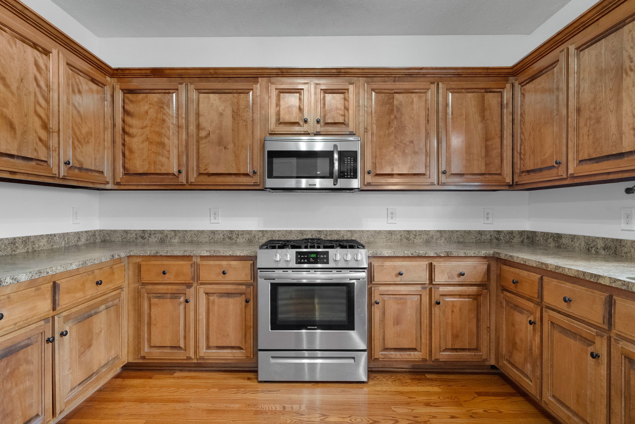 1026 Bluejay Lane Adams, TN 37010 - Photo 22 of 56 a kitchen with white cabinets and a stove top oven