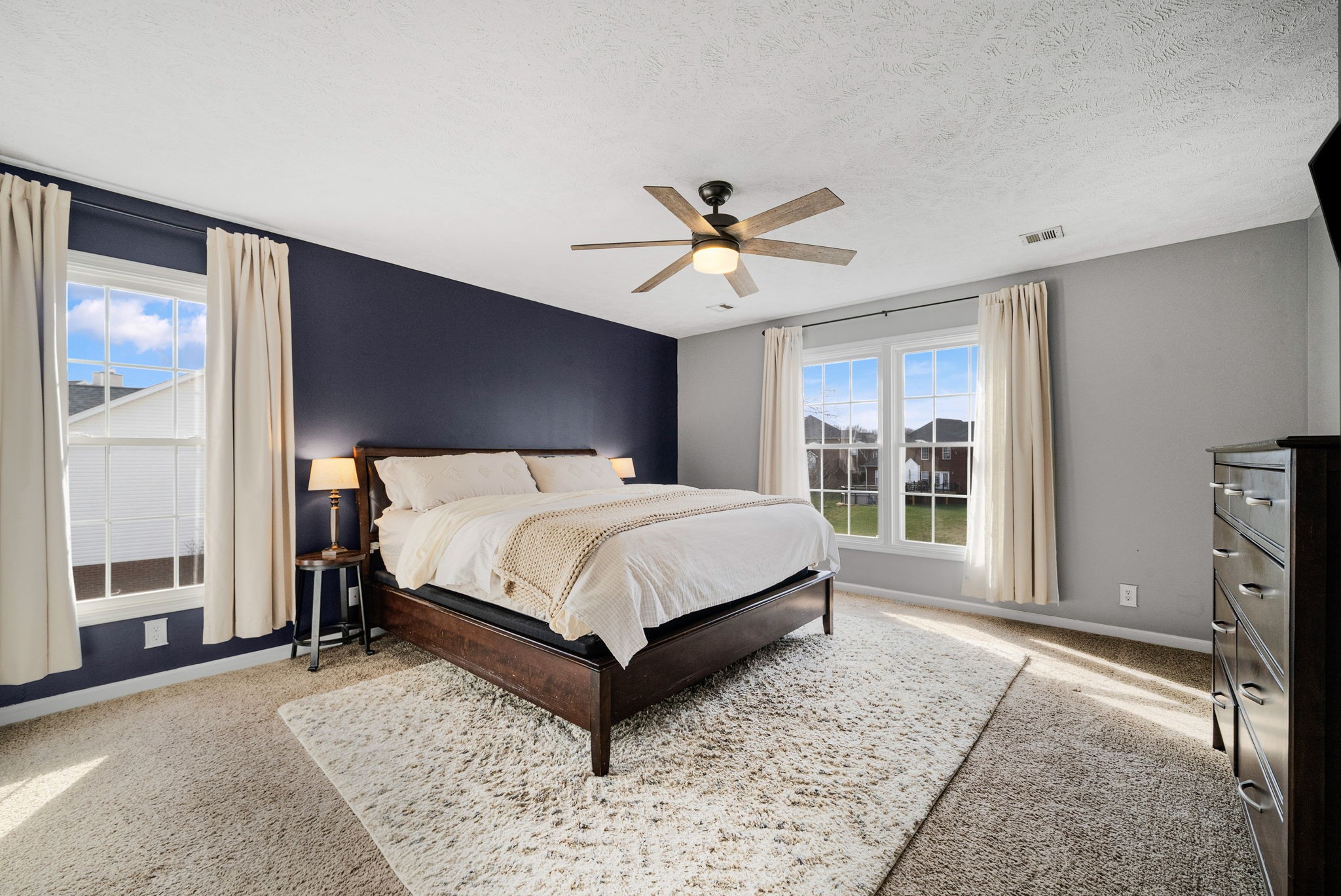 1026 Bluejay Lane Adams, TN 37010 - Photo 28 of 56 a bed sitting in a spacious bedroom next to a window and a chandelier