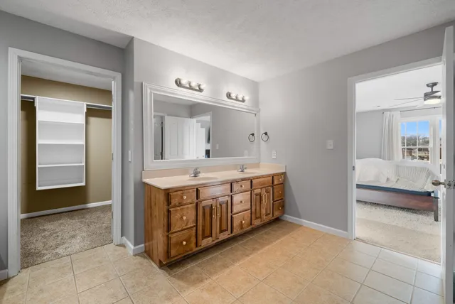 a bedroom with furniture and a large window