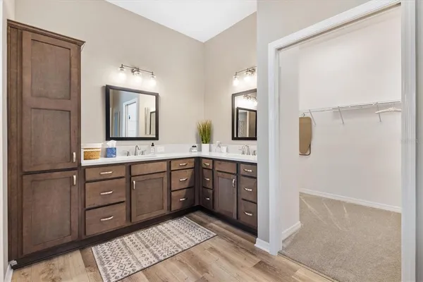 a bathroom with a double vanity sink and mirror