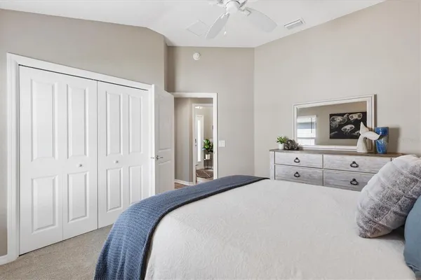 a bedroom with a bed and a mirror