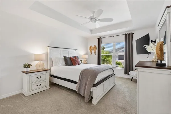 a bed room with a bed and a chandelier