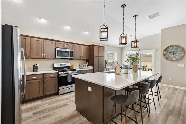 a kitchen with appliances cabinets a sink and a stove