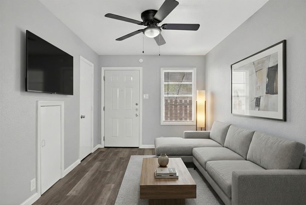4721 Tremont Street Dallas, TX 75246 - Photo 1 of 22 a living room with furniture and a flat screen tv