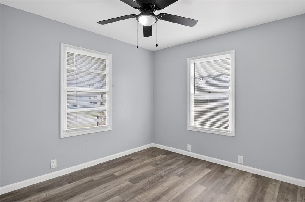 4721 Tremont Street Dallas, TX 75246 - Photo 13 of 22 a view of an empty room with a window and wooden floor