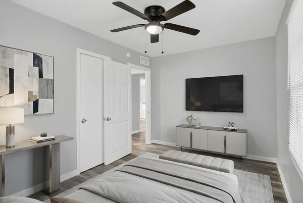 a bedroom with a bed and a flat screen tv