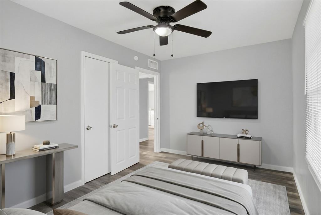 4721 Tremont Street Dallas, TX 75246 - Photo 16 of 22 a bedroom with a bed and a flat screen tv