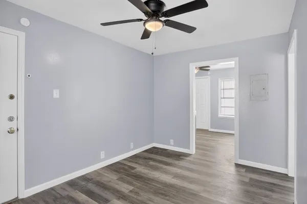 a view of empty room with wooden floor
