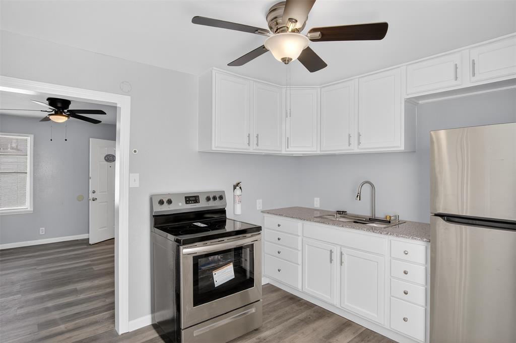 4721 Tremont Street Dallas, TX 75246 - Photo 4 of 22 a kitchen with appliances cabinets and a counter top space