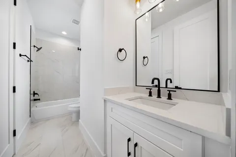 a bathroom with a toilet and a bathtub