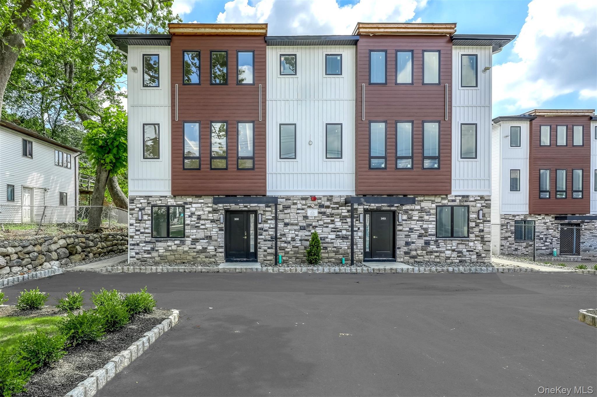 128 Union Road, Unit 202 Spring Valley, NY 10977 - Photo 1 of 1 a front view of a house with a garden
