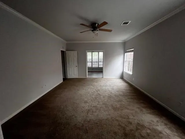 a view of a livingroom with a ceiling fan and window