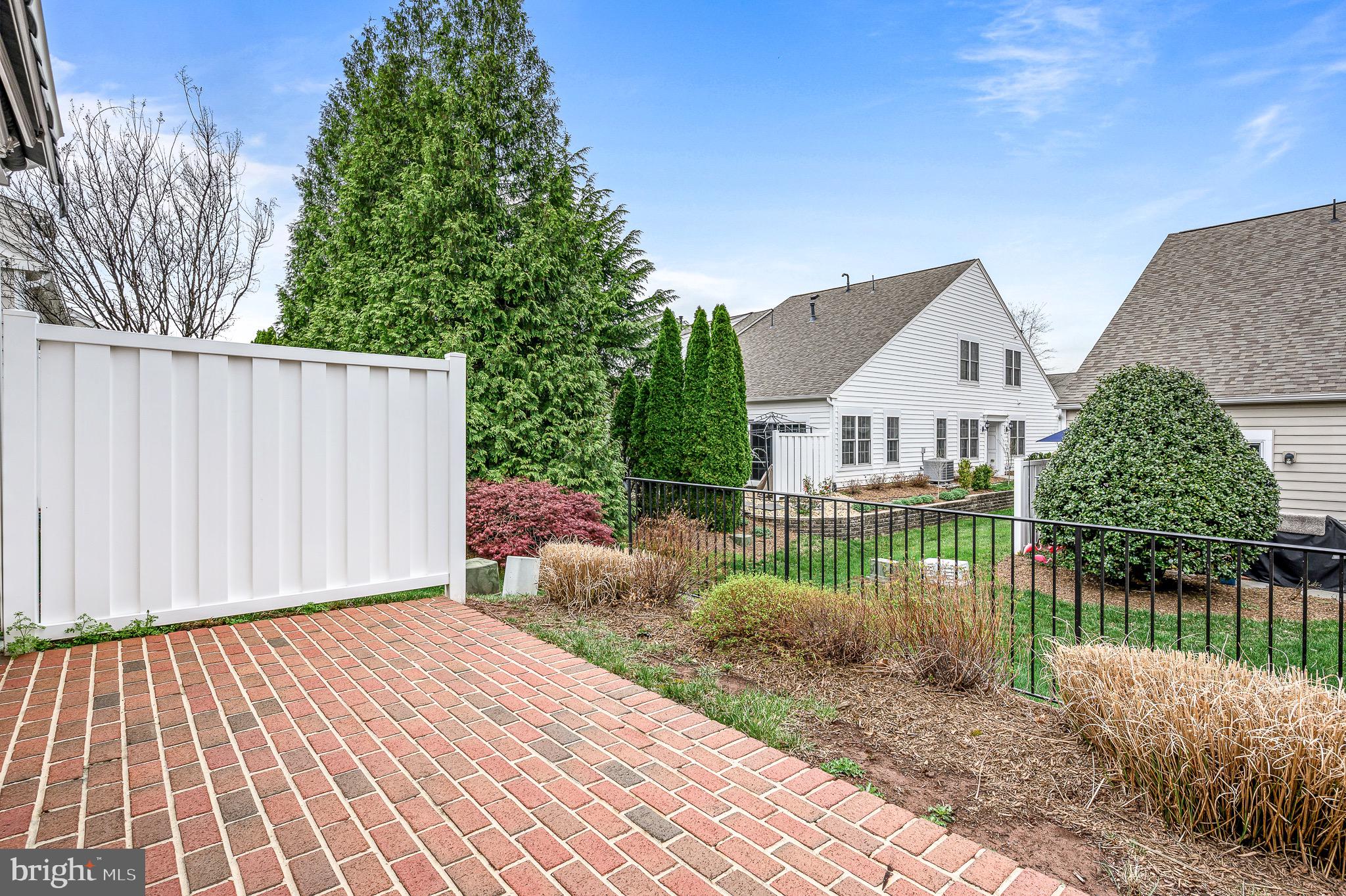 44422 Sunset Maple Drive Ashburn, VA 20147 - Photo 11 of 40 a view of a house with a wooden deck and a yard