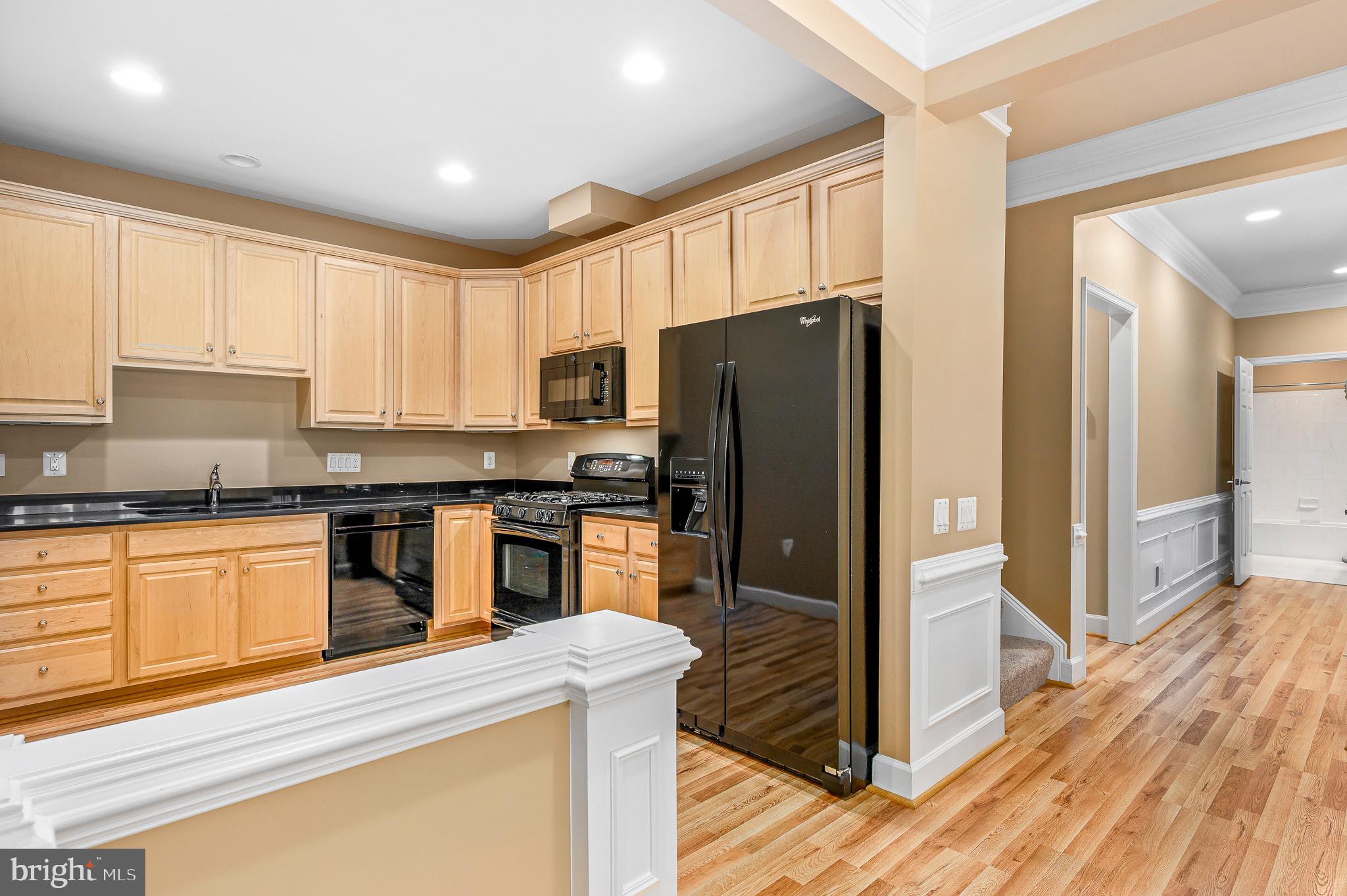 44422 Sunset Maple Drive Ashburn, VA 20147 - Photo 17 of 40 a kitchen with stainless steel appliances granite countertop a refrigerator stove and sink