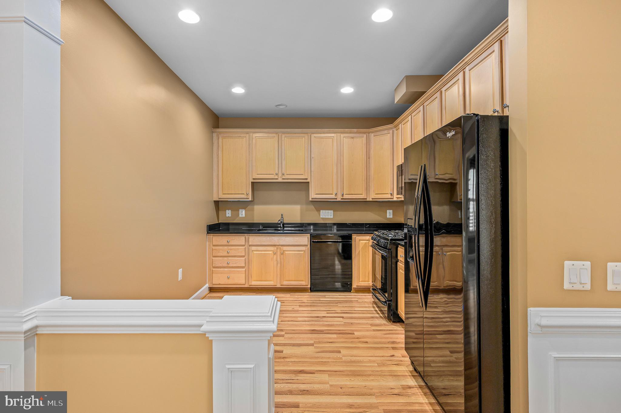 44422 Sunset Maple Drive Ashburn, VA 20147 - Photo 18 of 40 a kitchen with stainless steel appliances granite countertop a refrigerator and a stove top oven