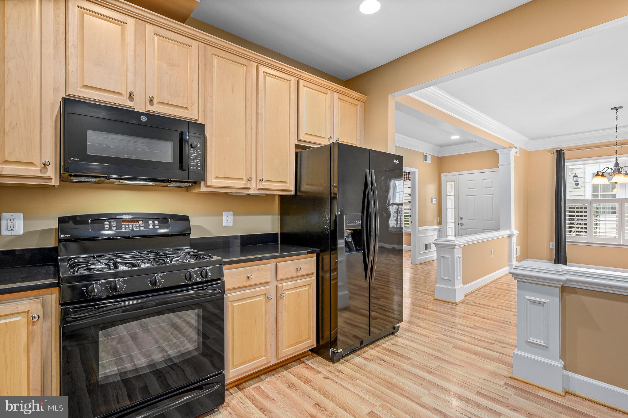 44422 Sunset Maple Drive Ashburn, VA 20147 - Photo 19 of 40 a kitchen with stainless steel appliances a stove a microwave and cabinets