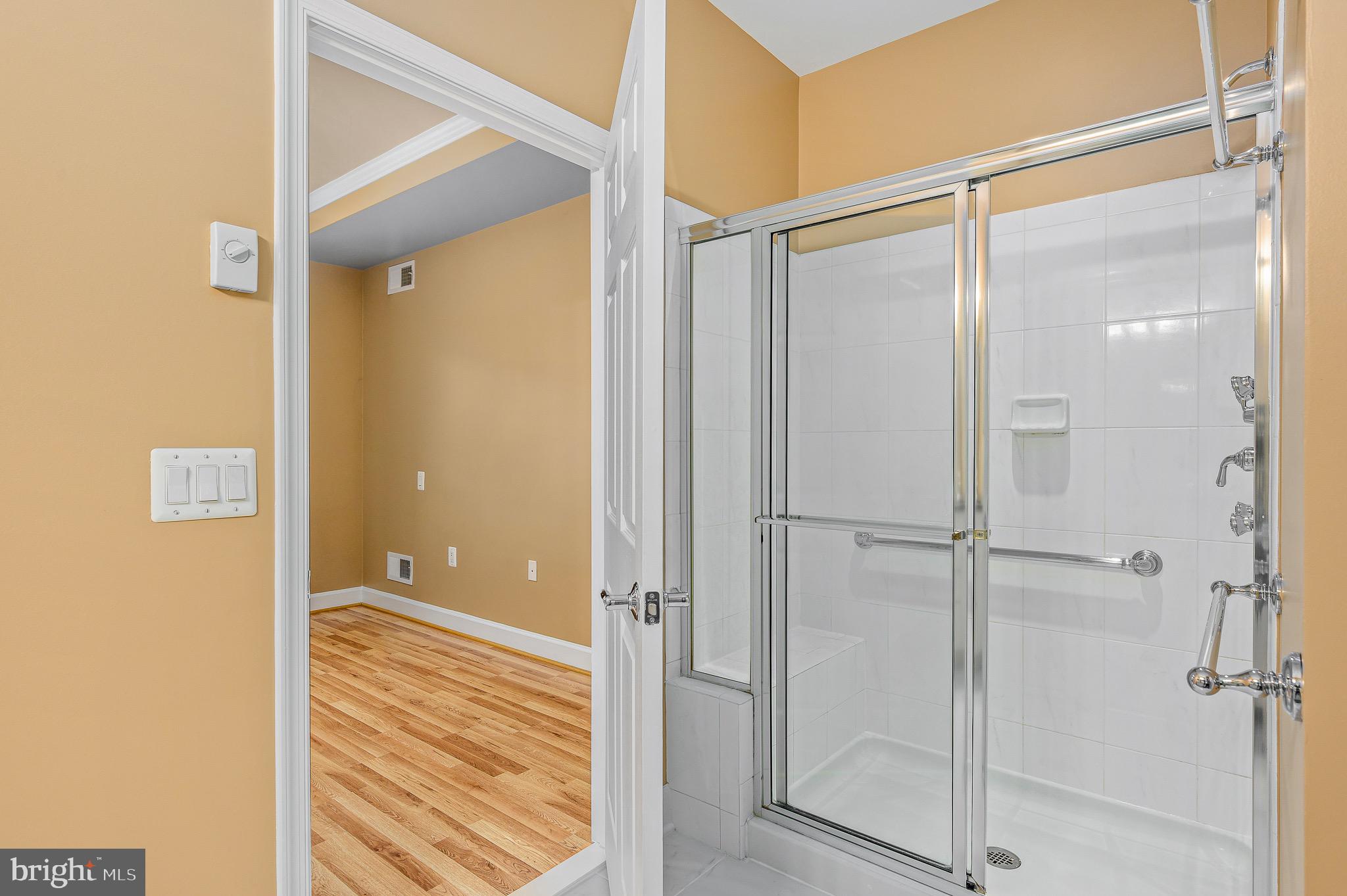 44422 Sunset Maple Drive Ashburn, VA 20147 - Photo 28 of 40 a bathroom with a glass shower door