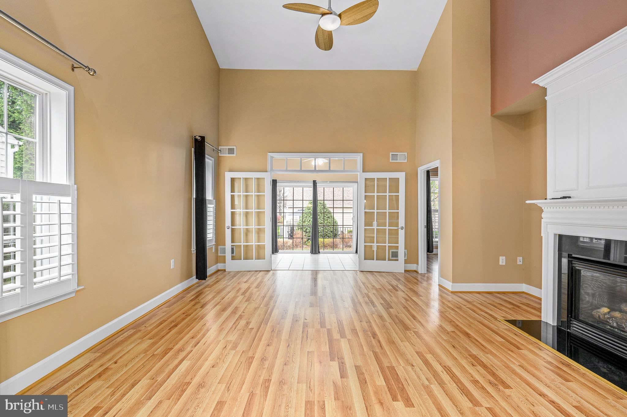 44422 Sunset Maple Drive Ashburn, VA 20147 - Photo 3 of 40 a view of an empty room with wooden floor and a window