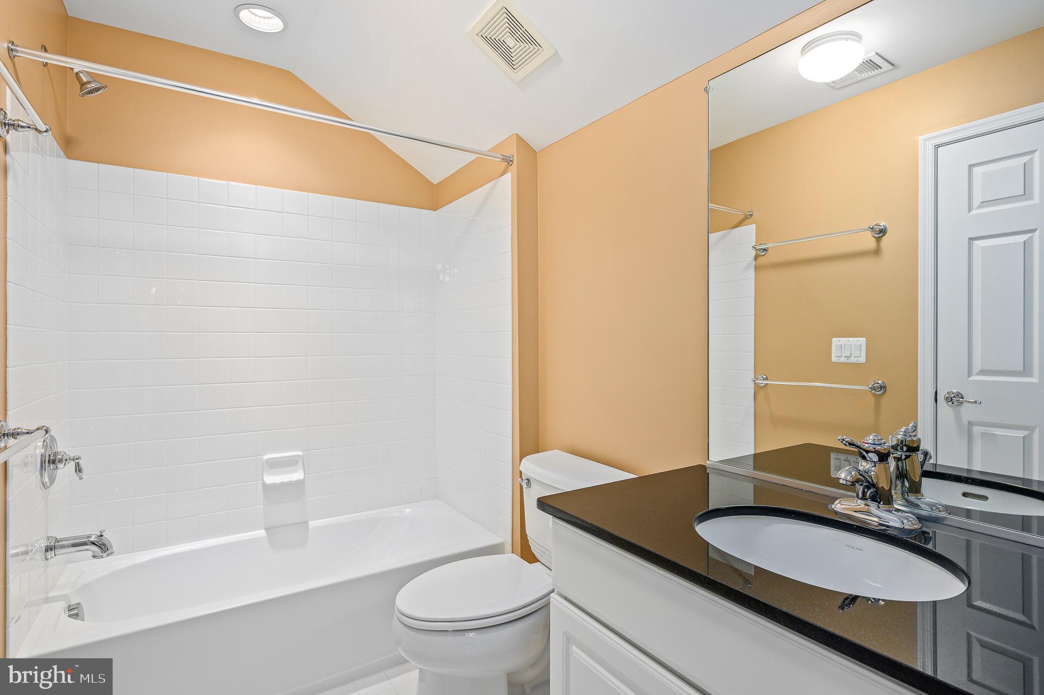 44422 Sunset Maple Drive Ashburn, VA 20147 - Photo 40 of 40 a bathroom with a granite countertop sink toilet a mirror and shower