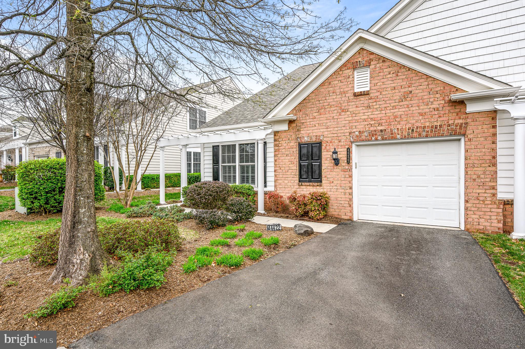 44422 Sunset Maple Drive Ashburn, VA 20147 - Photo 6 of 40 a front view of a house with a yard and garage