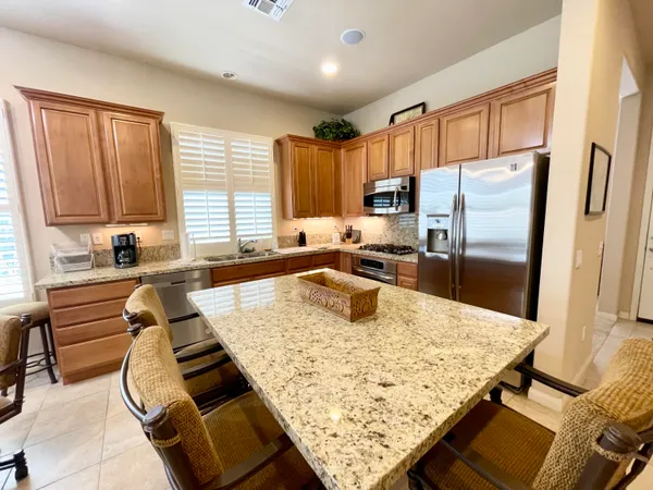 a kitchen with wooden cabinets and refrigerator